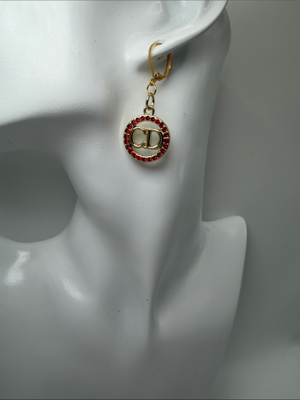 1471. Gold-Tone Red Crystal Hoop Earrings with CD Motif